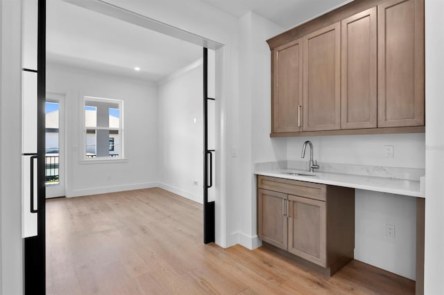 3406 W Alline Ave, Tampa, FL 33611 - bar area with a sink, light wood-type flooring, baseboards, and crown molding