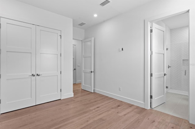 3406 W Alline Ave, Tampa, FL 33611 - unfurnished bedroom with light wood finished floors, recessed lighting, ensuite bathroom, baseboards, and a closet