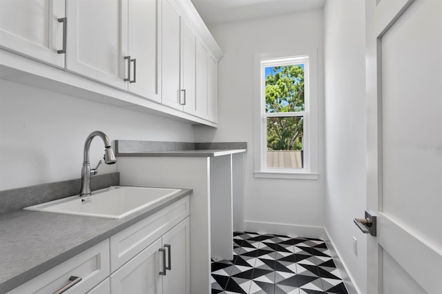 3406 W Alline Ave, Tampa, FL 33611 - washroom with a sink, baseboards, and tile patterned floors