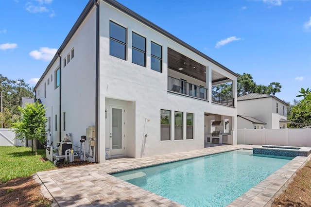 3406 W Alline Ave, Tampa, FL 33611 - rear view of property with a balcony, a patio, stucco siding, a fenced backyard, and a pool with connected hot tub