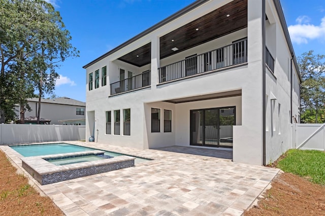 3406 W Alline Ave, Tampa, FL 33611 - rear view of property with a balcony, stucco siding, a patio area, a fenced backyard, and a pool with connected hot tub