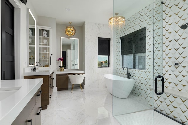 full bathroom featuring a shower stall, an inviting chandelier, and a sink