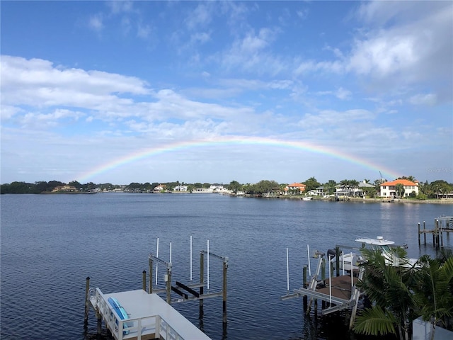 dock area with boat lift and a water view