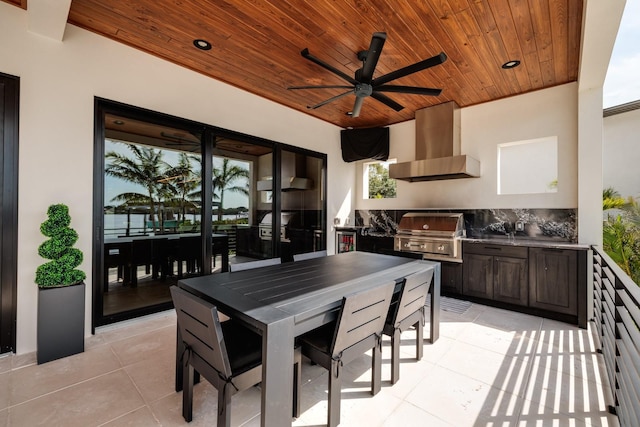 interior space featuring outdoor dining area, an outdoor kitchen, ceiling fan, and grilling area