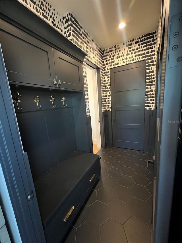 mudroom with dark tile patterned flooring