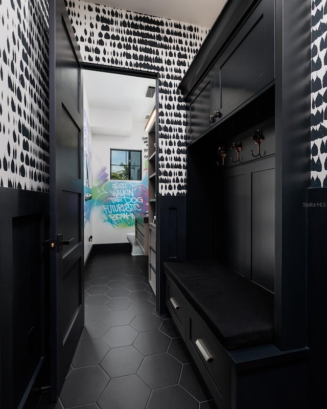 mudroom with dark tile patterned flooring