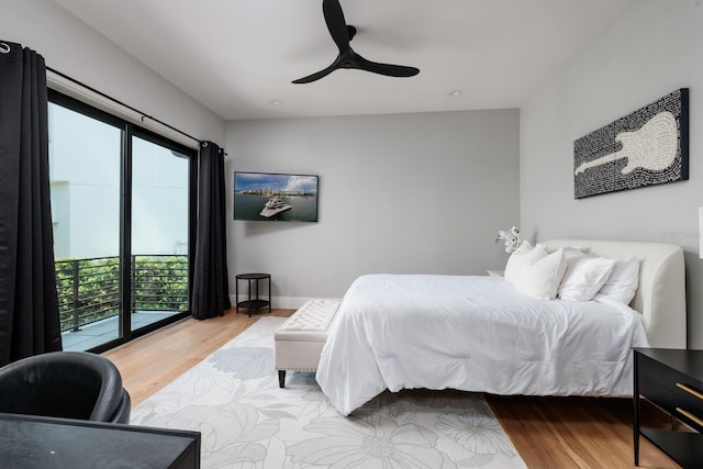 bedroom featuring wood finished floors, a ceiling fan, and access to exterior