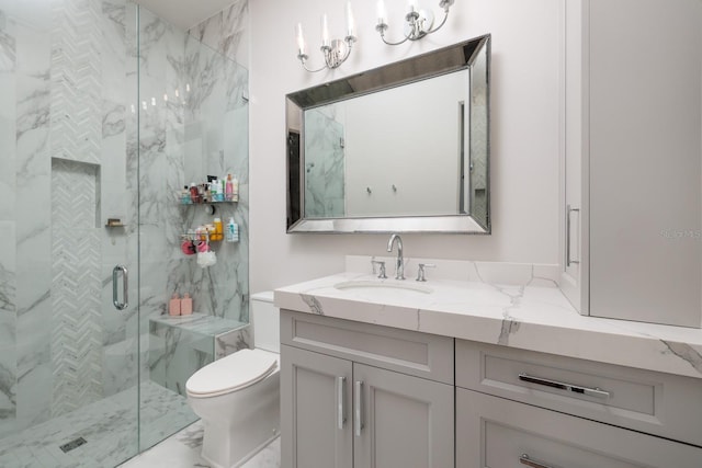 bathroom with toilet, vanity, a marble finish shower, and marble finish floor