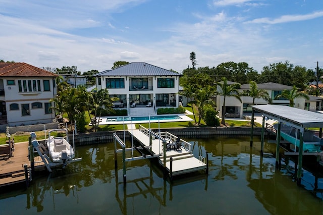 view of dock featuring a balcony, a residential view, boat lift, an outdoor pool, and a water view