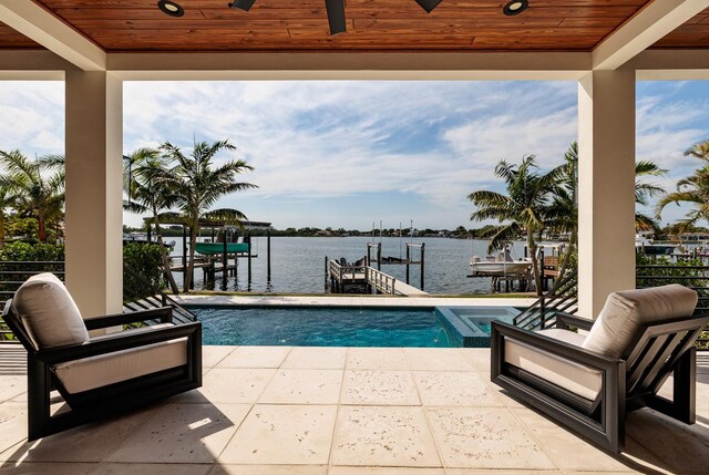 view of pool featuring a water view, a boat dock, and boat lift