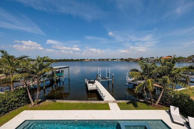 dock area with an outdoor pool, boat lift, and a water view