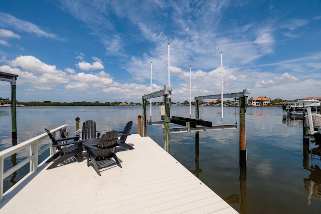 dock area with boat lift and a water view
