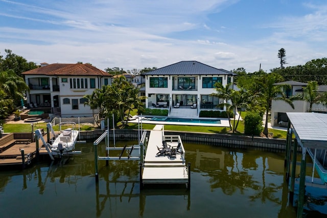 dock area with a balcony, a patio, boat lift, an outdoor pool, and a water view