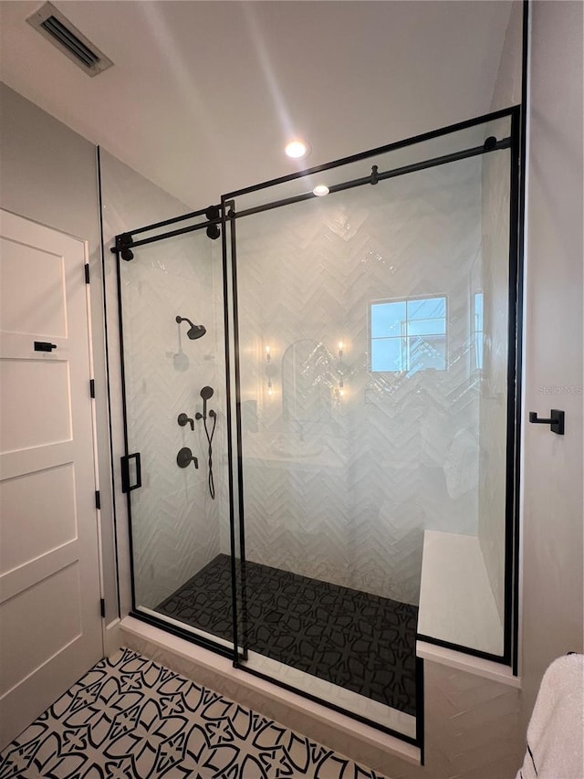bathroom featuring a stall shower and visible vents