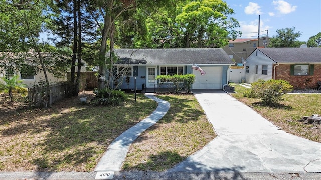 view of front of home with a front lawn, fence, a garage, and concrete driveway