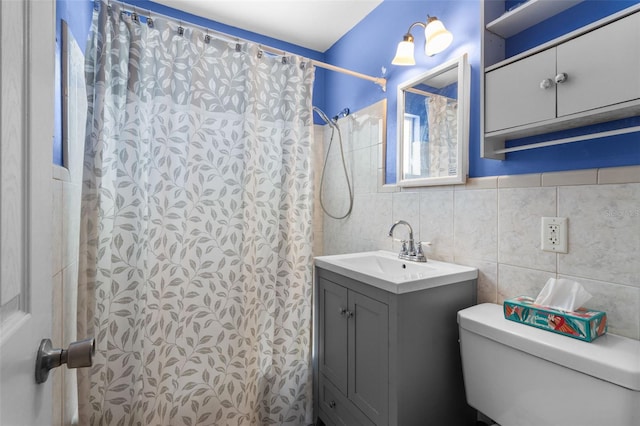 bathroom featuring curtained shower, vanity, tile walls, and toilet