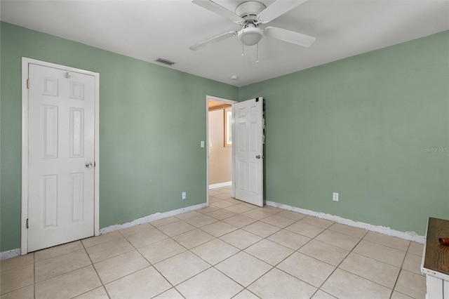 unfurnished bedroom with ceiling fan, baseboards, and visible vents
