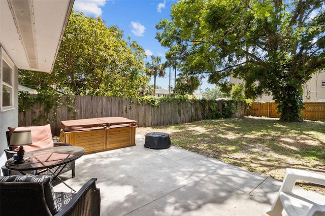 view of patio / terrace with a fenced backyard and a hot tub
