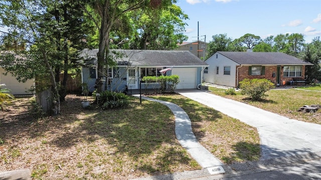 ranch-style home featuring a garage, brick siding, driveway, and a front lawn
