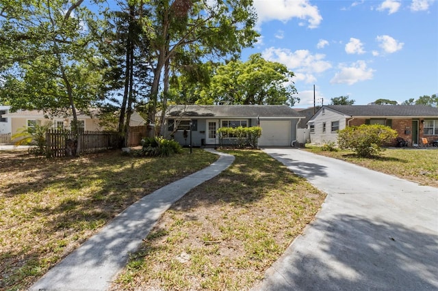 ranch-style house with driveway, a garage, fence, and a front lawn