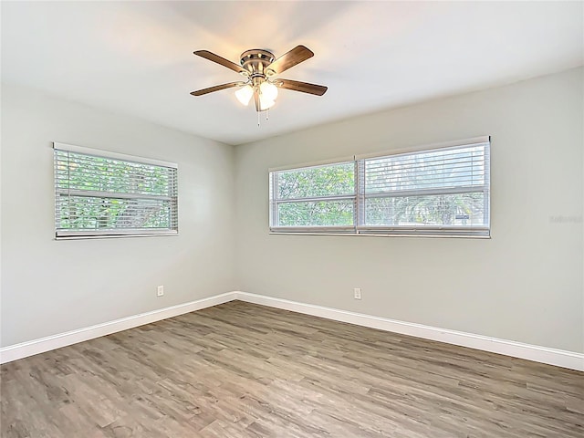 unfurnished room featuring baseboards and a wealth of natural light