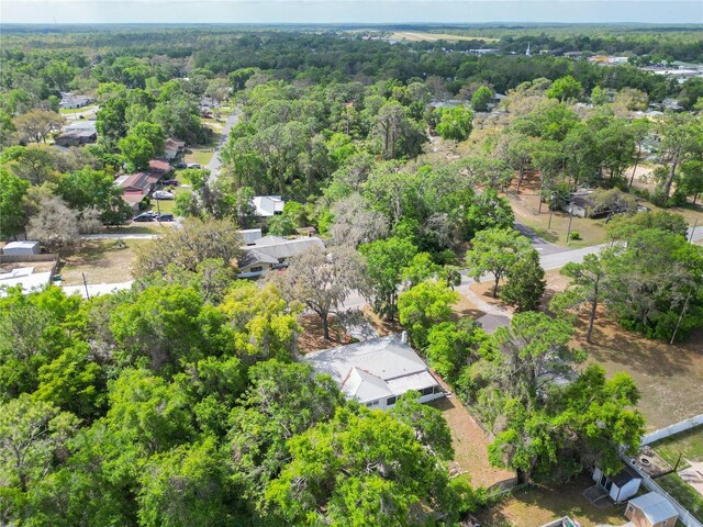 drone / aerial view with a wooded view