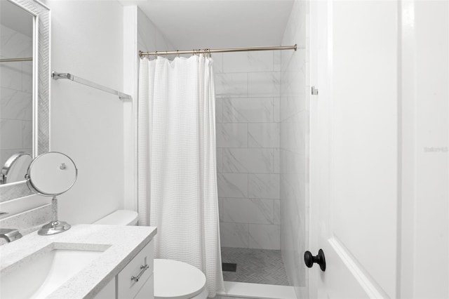 full bath with toilet, vanity, and a shower stall