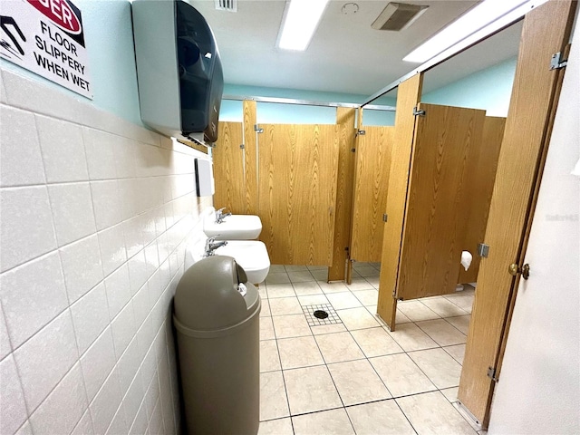1423 Pine Glen Ln Unit D2, Tarpon Springs, FL 34688 - bathroom with a bidet, toilet, wooden walls, and tile patterned flooring