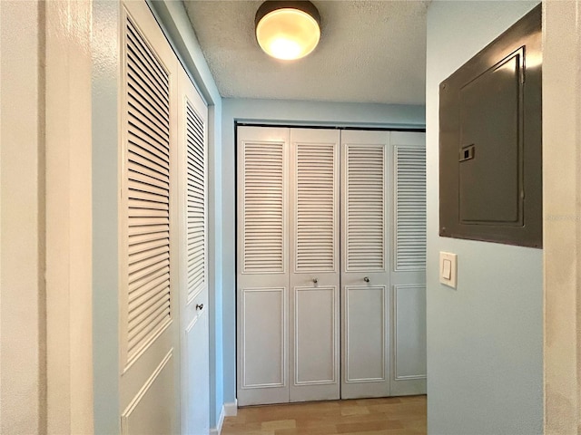 1423 Pine Glen Ln Unit D2, Tarpon Springs, FL 34688 - hallway with electric panel and light wood-style flooring