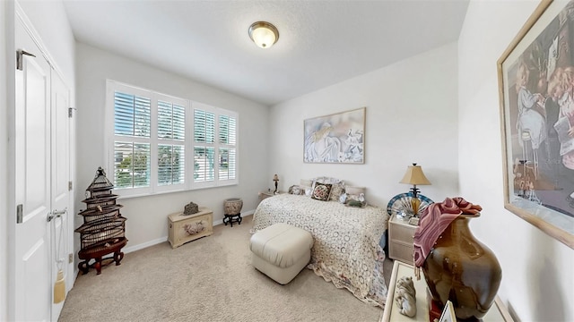 carpeted bedroom with baseboards