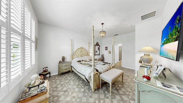 bedroom with baseboards and visible vents