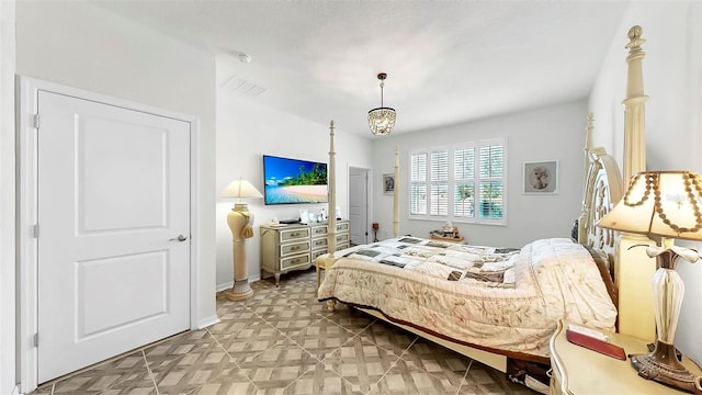 bedroom with baseboards, a chandelier, and visible vents
