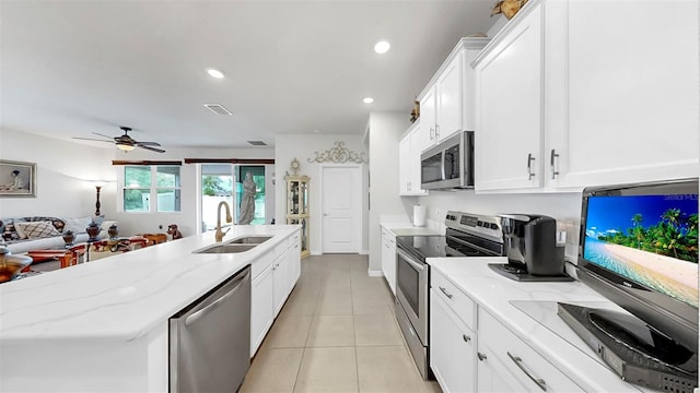kitchen with white cabinets, a sink, stainless steel appliances, and visible vents