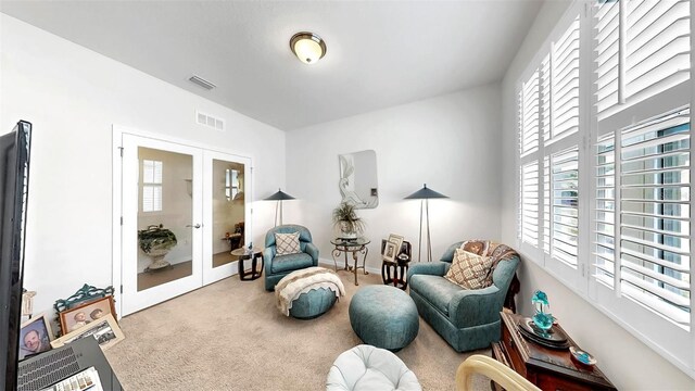 living area featuring french doors, carpet floors, baseboards, and visible vents
