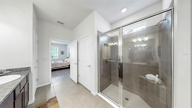 ensuite bathroom featuring a stall shower, vanity, tile patterned flooring, ensuite bathroom, and visible vents