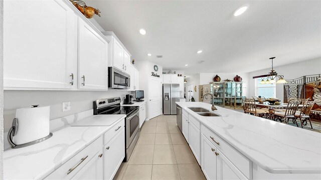 kitchen featuring a sink, white cabinetry, appliances with stainless steel finishes, light tile patterned floors, and recessed lighting