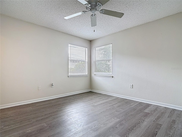 spare room with baseboards, wood finished floors, ceiling fan, and a textured ceiling