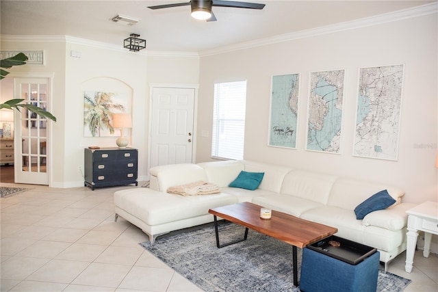 living room with light tile patterned flooring, visible vents, crown molding, and ceiling fan