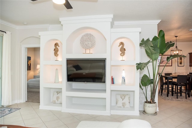 living area with ornamental molding, built in shelves, ceiling fan, and tile patterned flooring