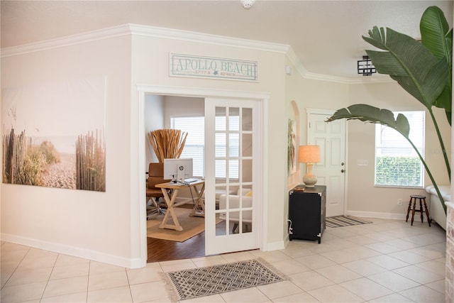 foyer entrance featuring tile patterned flooring, baseboards, and ornamental molding