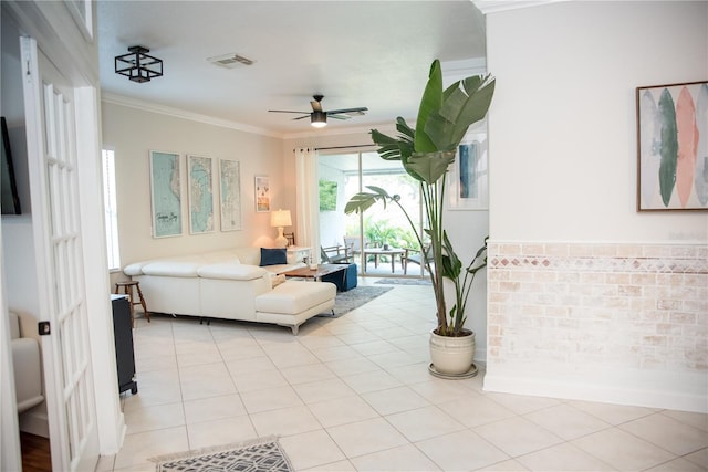 living area featuring crown molding, ceiling fan, visible vents, and light tile patterned floors