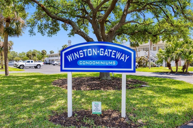 1000 79th Ave N Unit 211, Saint Petersburg, FL 33702 - community / neighborhood sign featuring a lawn and uncovered parking