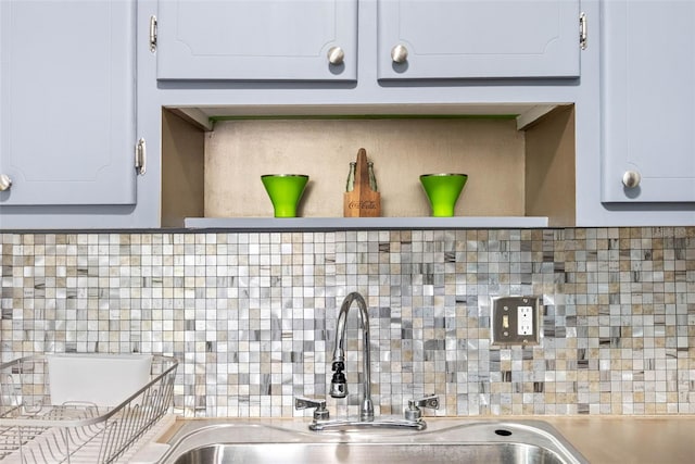 1000 79th Ave N Unit 211, Saint Petersburg, FL 33702 - kitchen view of backsplash, a sink, open shelves, and light countertops