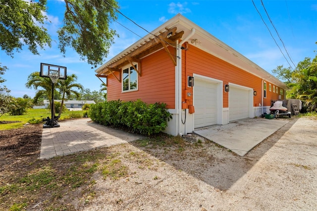 2623 57th St S, Gulfport, FL 33707 - view of home's exterior featuring an attached garage and driveway
