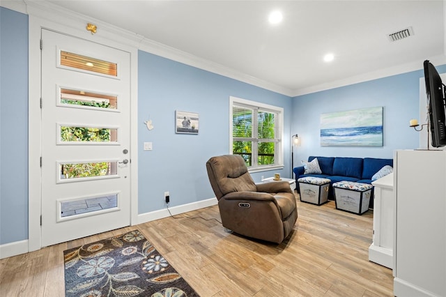 2623 57th St S, Gulfport, FL 33707 - living area with light wood-type flooring, baseboards, ornamental molding, and visible vents