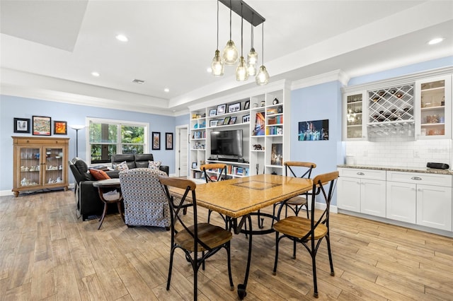 2623 57th St S, Gulfport, FL 33707 - dining area featuring baseboards, recessed lighting, light wood-style floors, visible vents, and a raised ceiling