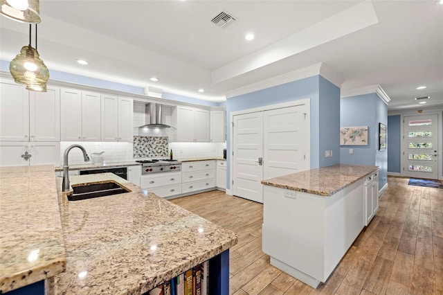2623 57th St S, Gulfport, FL 33707 - kitchen featuring visible vents, wall chimney exhaust hood, a sink, decorative backsplash, and stainless steel gas cooktop