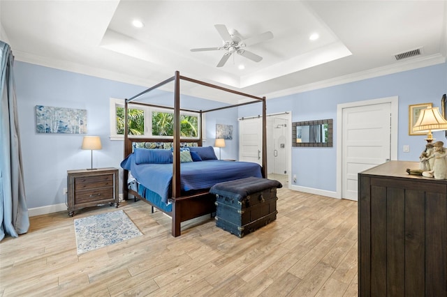 2623 57th St S, Gulfport, FL 33707 - bedroom with light wood-style floors, visible vents, a tray ceiling, and baseboards