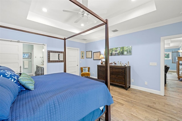 2623 57th St S, Gulfport, FL 33707 - bedroom featuring ornamental molding, a tray ceiling, baseboards, and light wood-type flooring