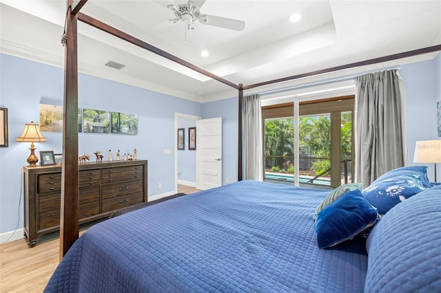 2623 57th St S, Gulfport, FL 33707 - bedroom with ornamental molding, a tray ceiling, light wood-type flooring, and visible vents
